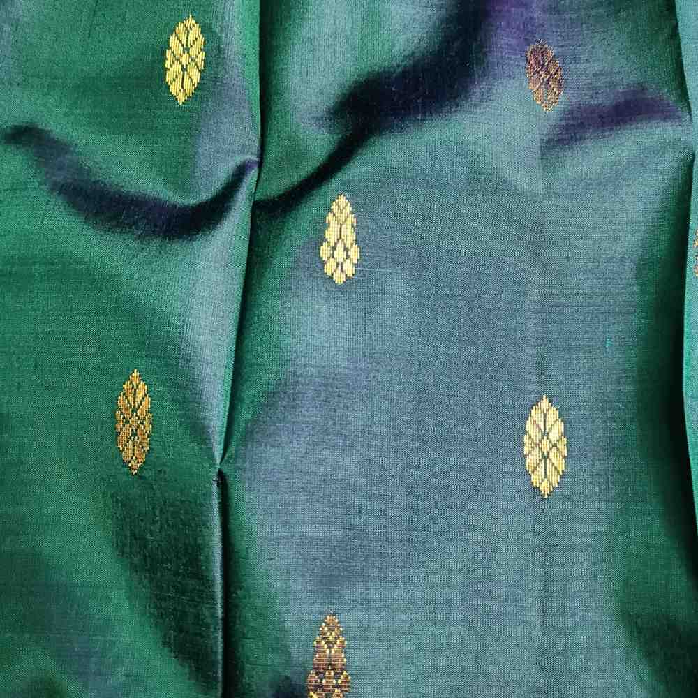 Green fabric with gold embroidered patterns