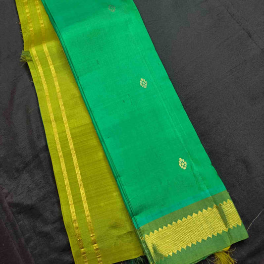 Green and yellow traditional fabric on a black background