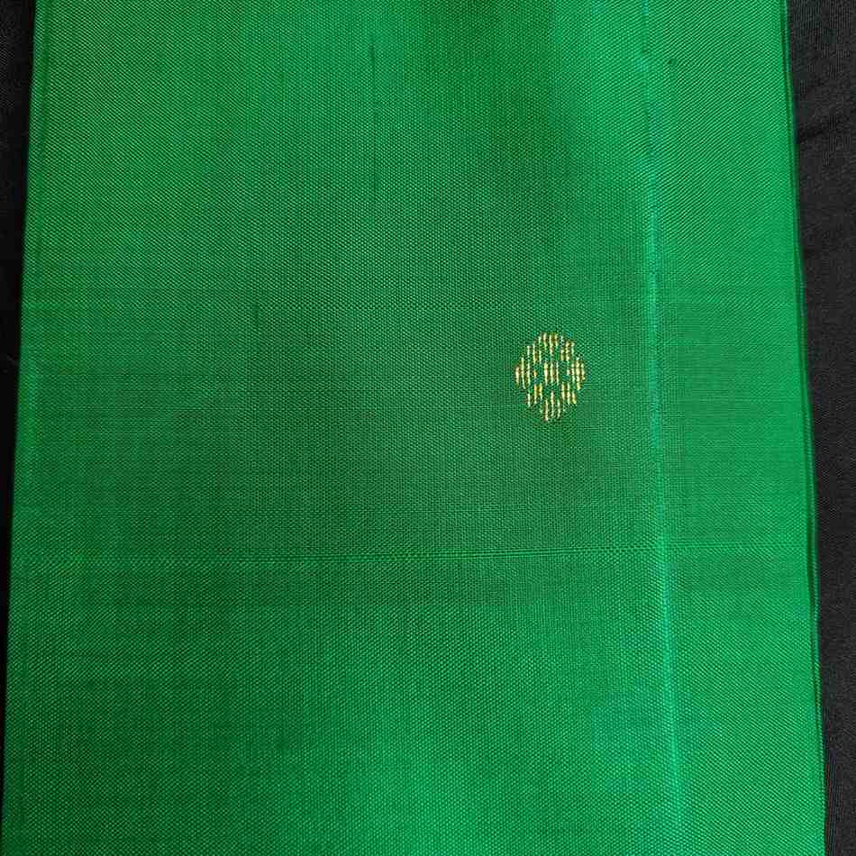 Green fabric with a small yellow pattern on a black background