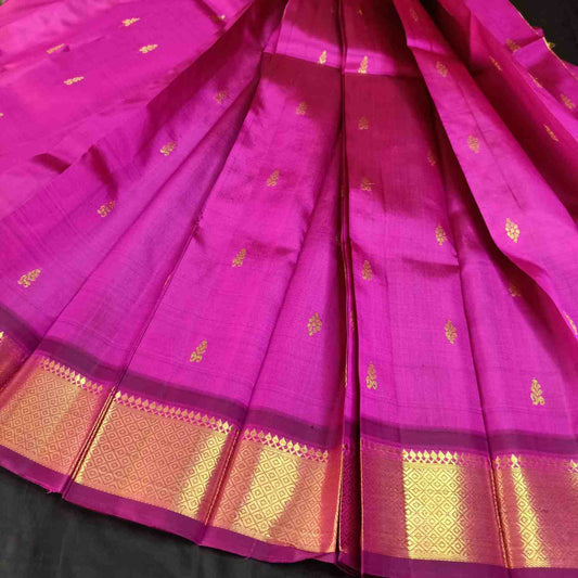 Pink saree with gold patterns on a black background