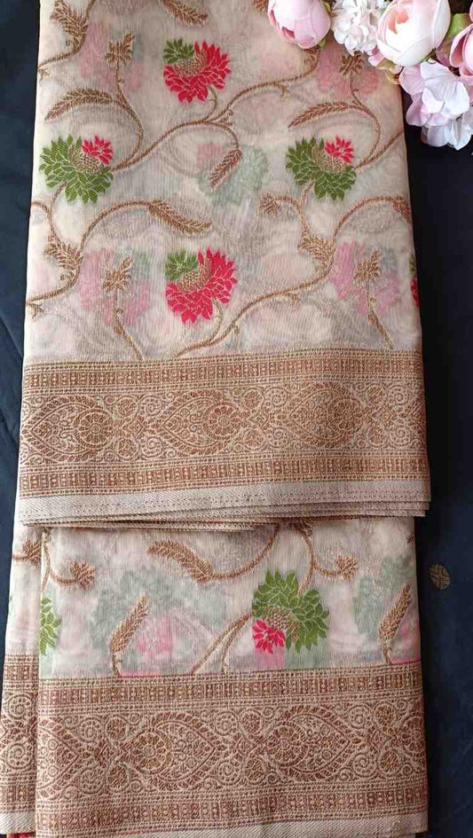 Decorative fabric with floral patterns and gold borders on a dark background