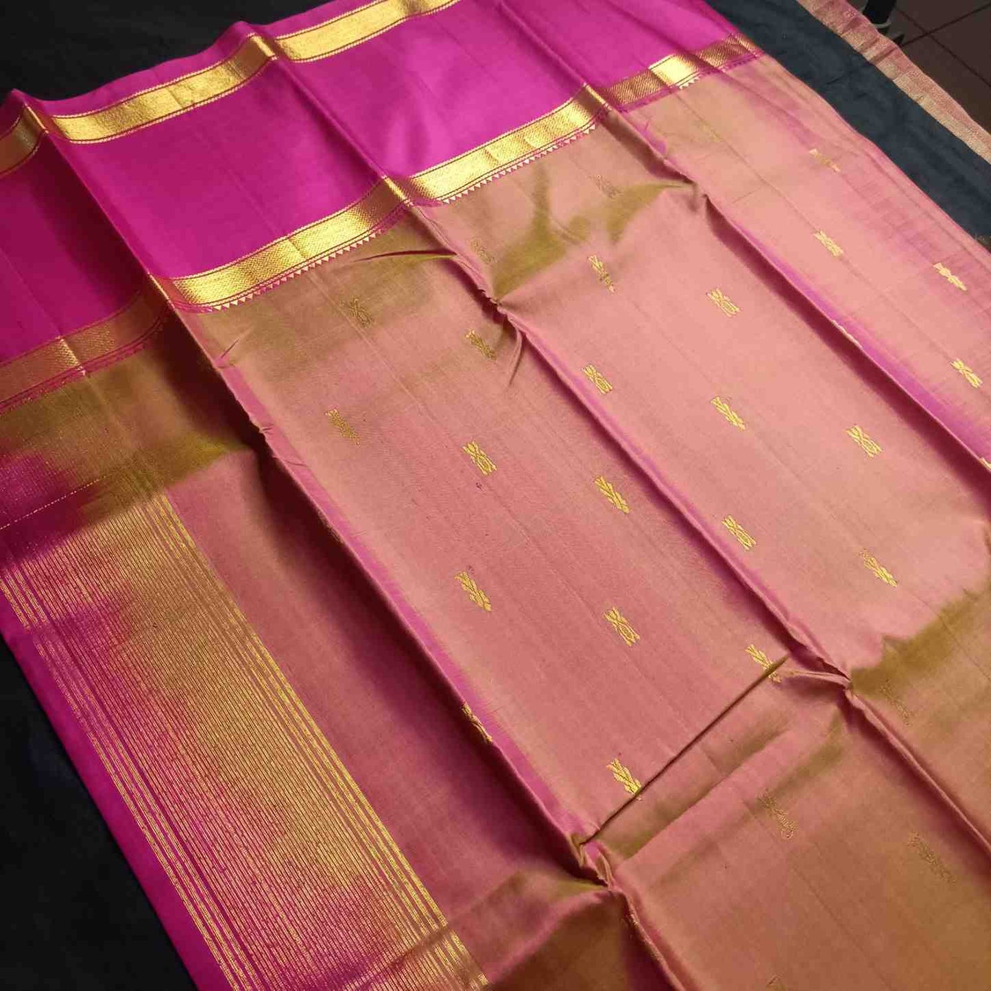 Honey gold Kanjivaram silk saree showing elegant drape and pleat formation
