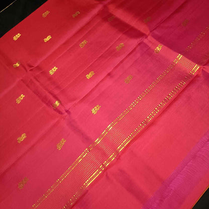 Contrast pink pallu with zari detailing on rust orange Kanjivaram silk saree