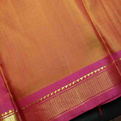 The backside hand woven border with Traditional saw-tooth Bhavanji border detail on earthy orange Kanjivaram saree