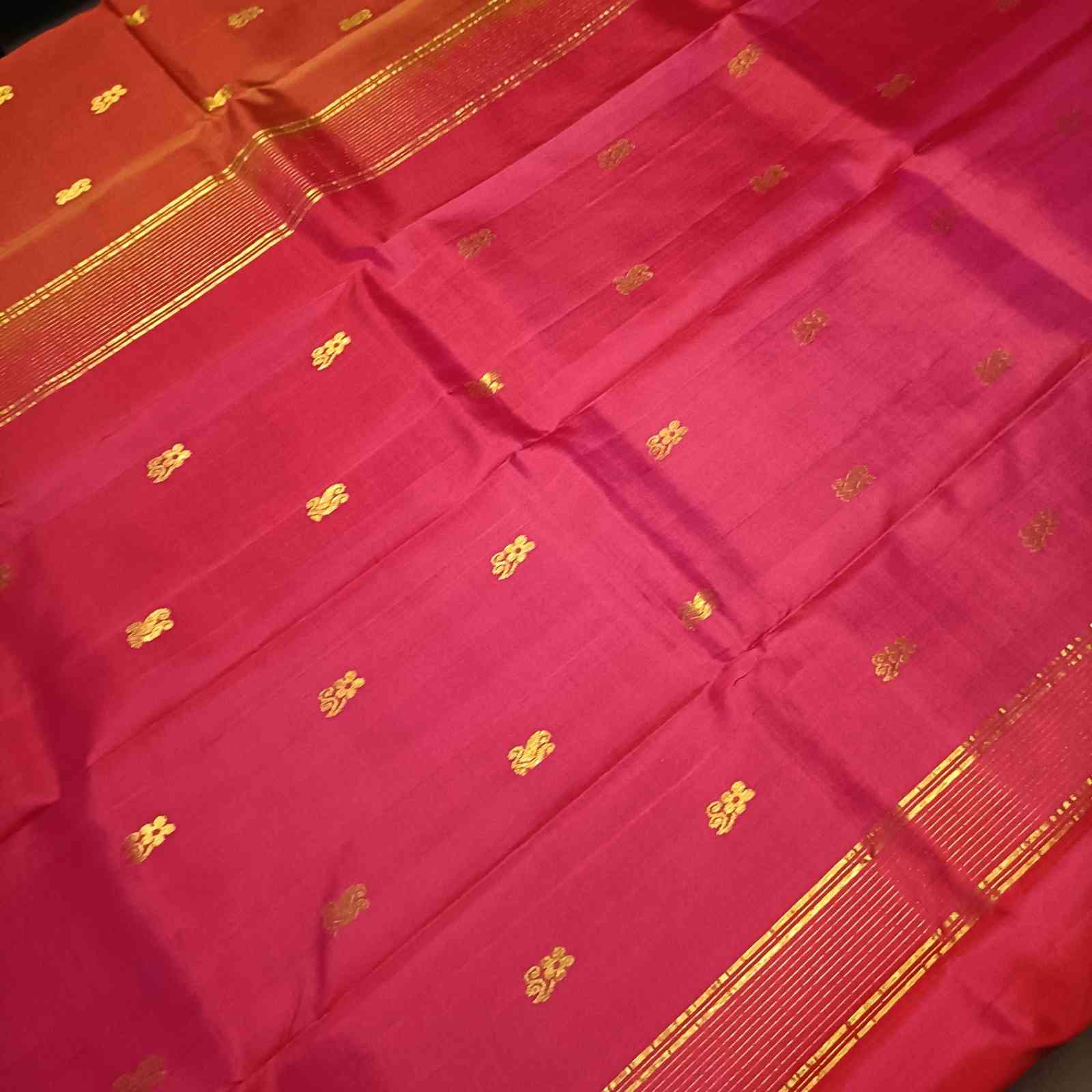 Contrast pink pallu with zari detailing on rust orange Kanjivaram silk saree