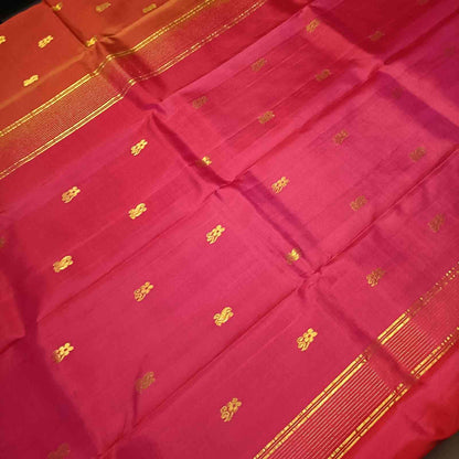 Contrast pink pallu with zari detailing on rust orange Kanjivaram silk saree