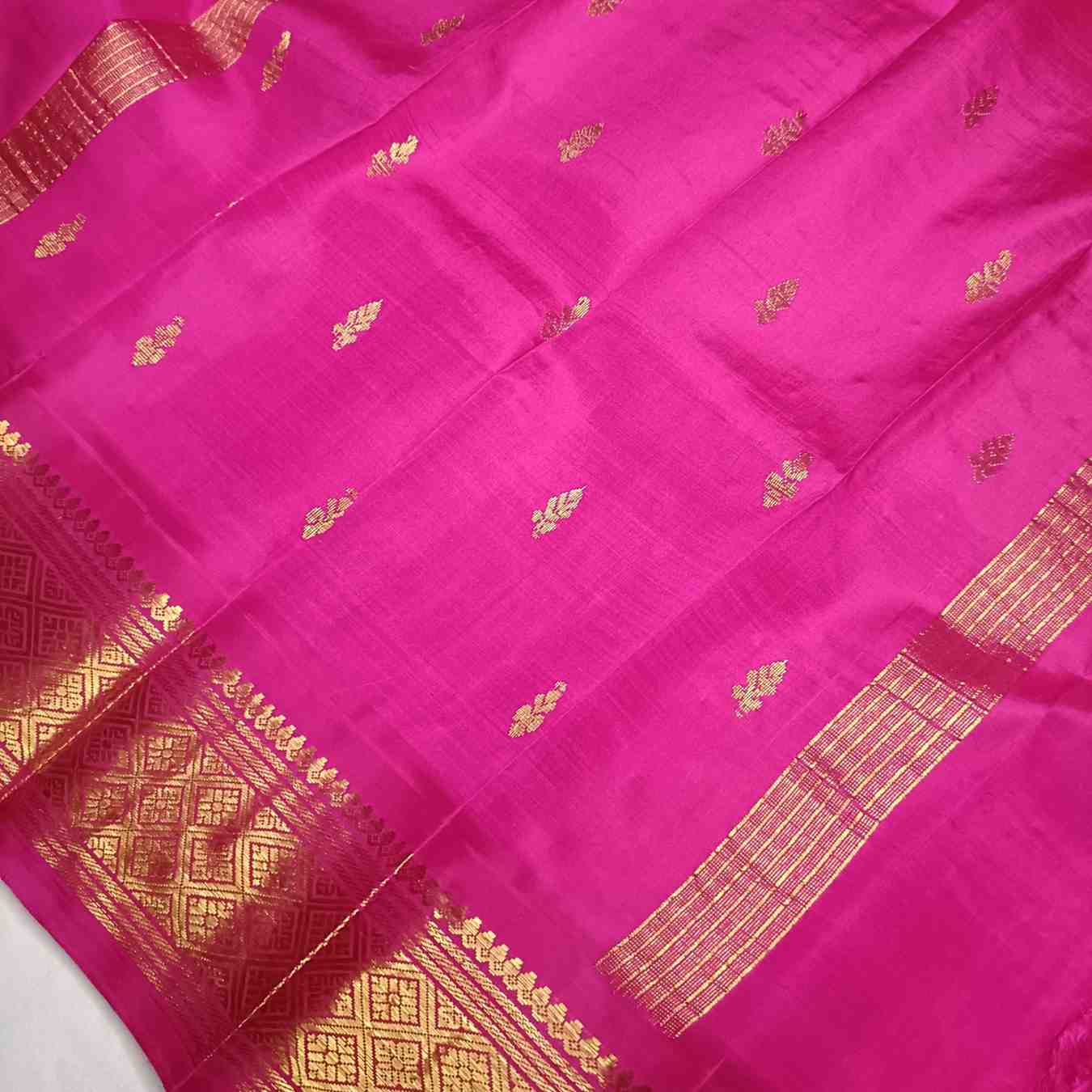 Rama Green and pink pallu with thin zari lines and small buttas  on Thirubhuvanam silk saree