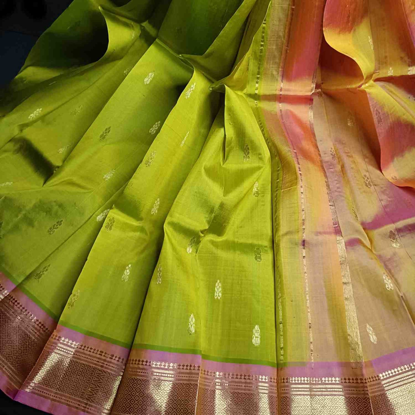 Pure handloom parrot green Thirubhuvanam silk saree with orange-pink Mayil Kan border full view