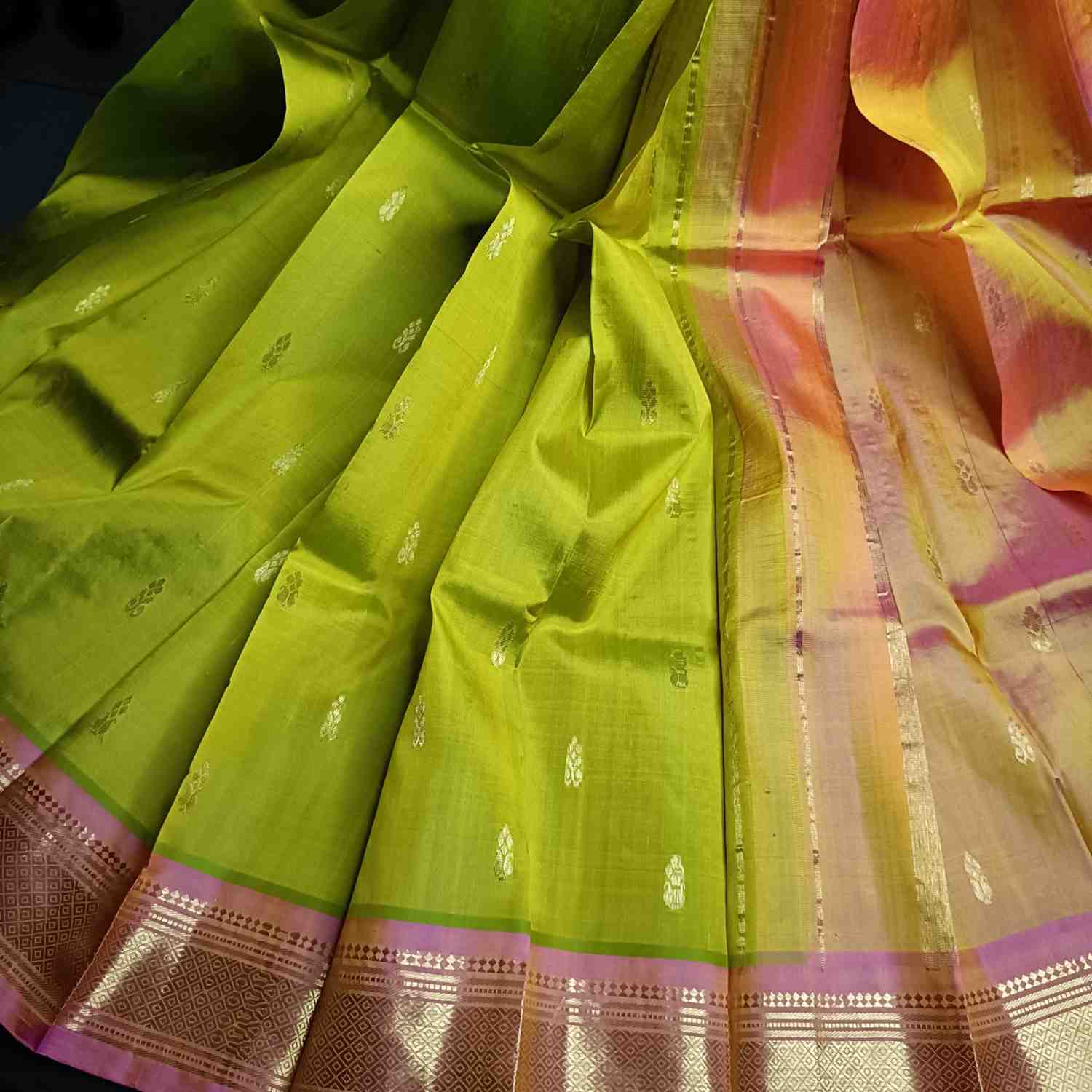 Pure handloom parrot green Thirubhuvanam silk saree with orange-pink Mayil Kan border full view