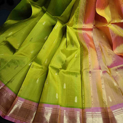 Pure handloom parrot green Thirubhuvanam silk saree with orange-pink Mayil Kan border full view