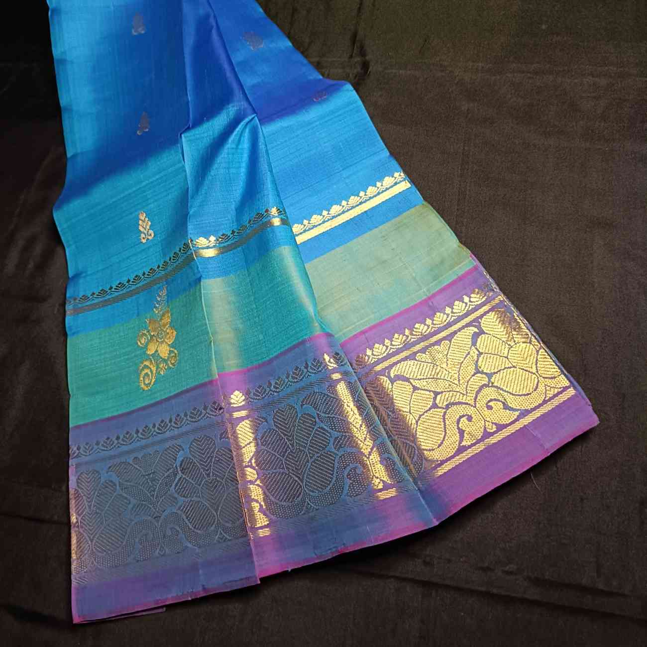 Handloom Thirubhuvanam pure silk saree texture showing poo motifs in antique zari on peacock blue body