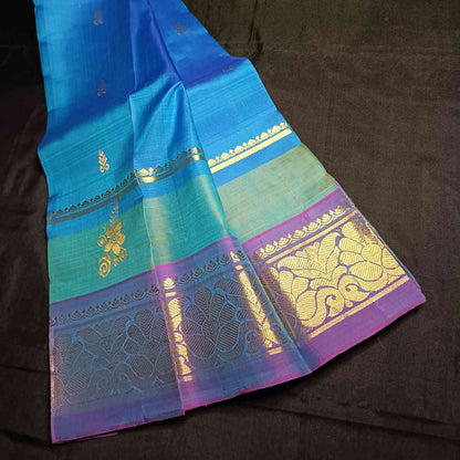 Handloom Thirubhuvanam pure silk saree texture showing poo motifs in antique zari on peacock blue body