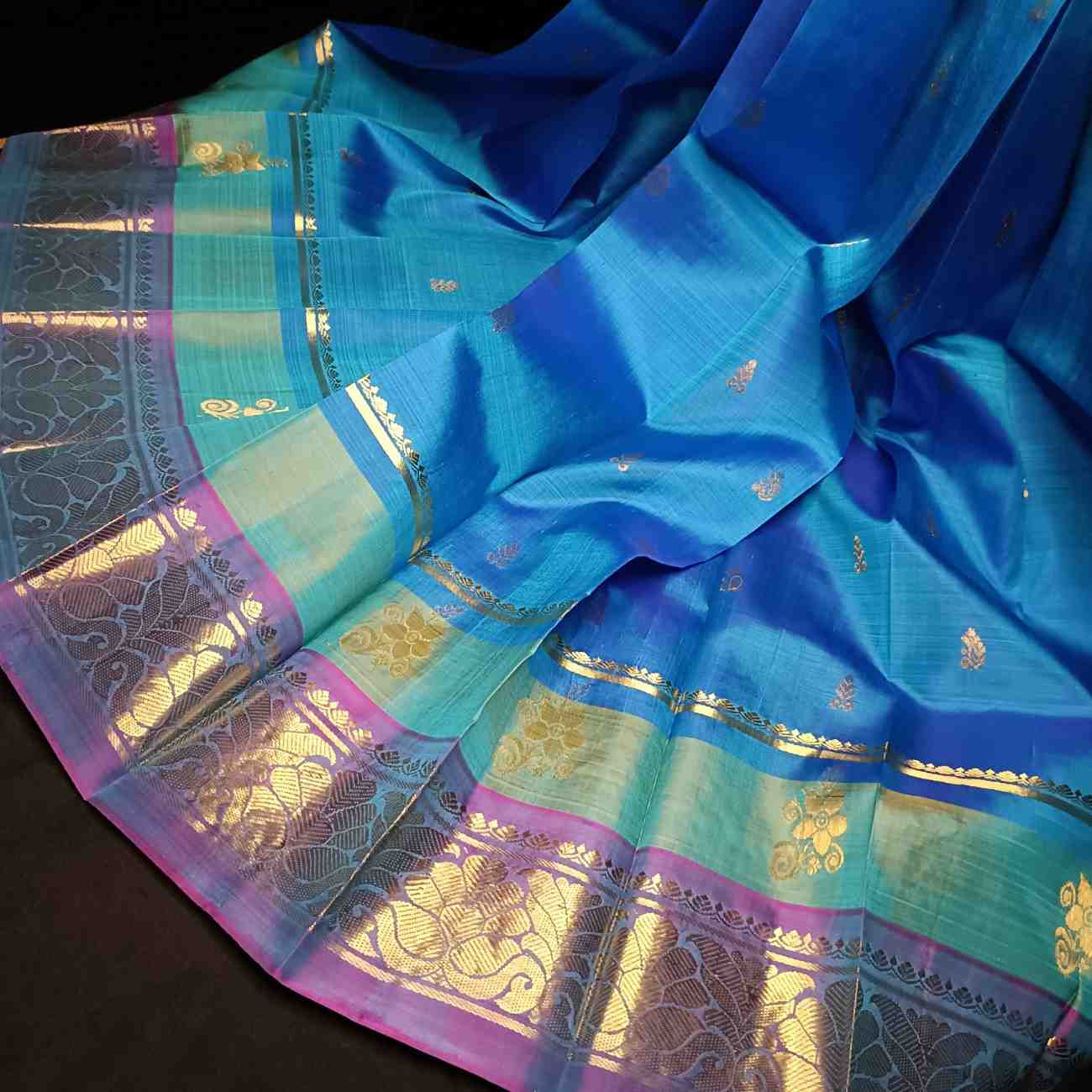 Handloom Thirubhuvanam pure silk saree texture showing poo motifs in antique zari on peacock blue body