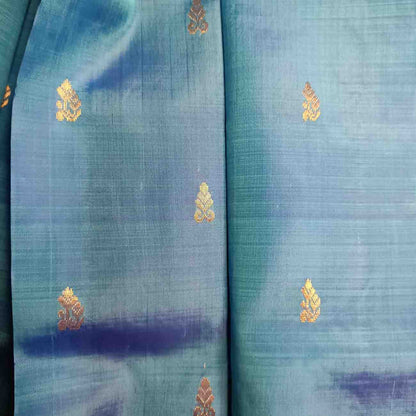 Handloom Thirubhuvanam pure silk saree texture showing poo motifs in antique zari on peacock blue body