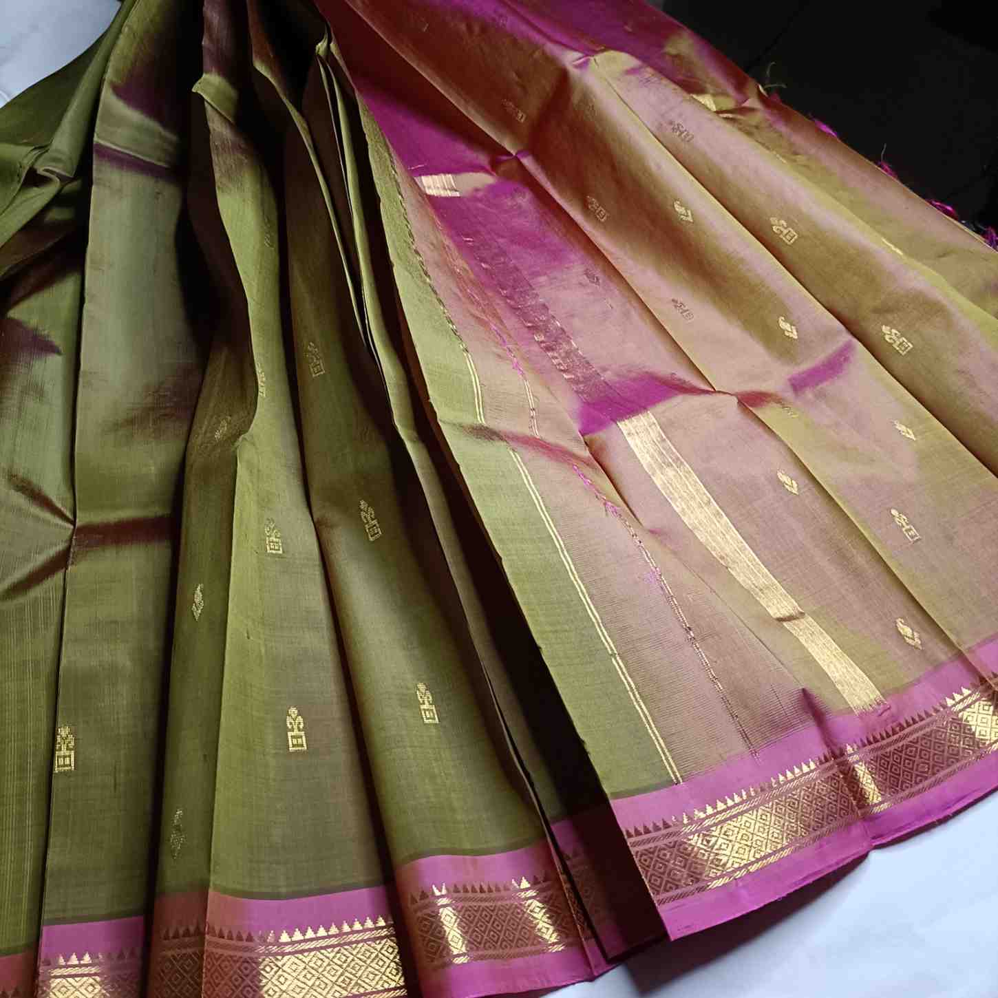 Olive Green Thirubhuvanam saree with pink contrast border detail