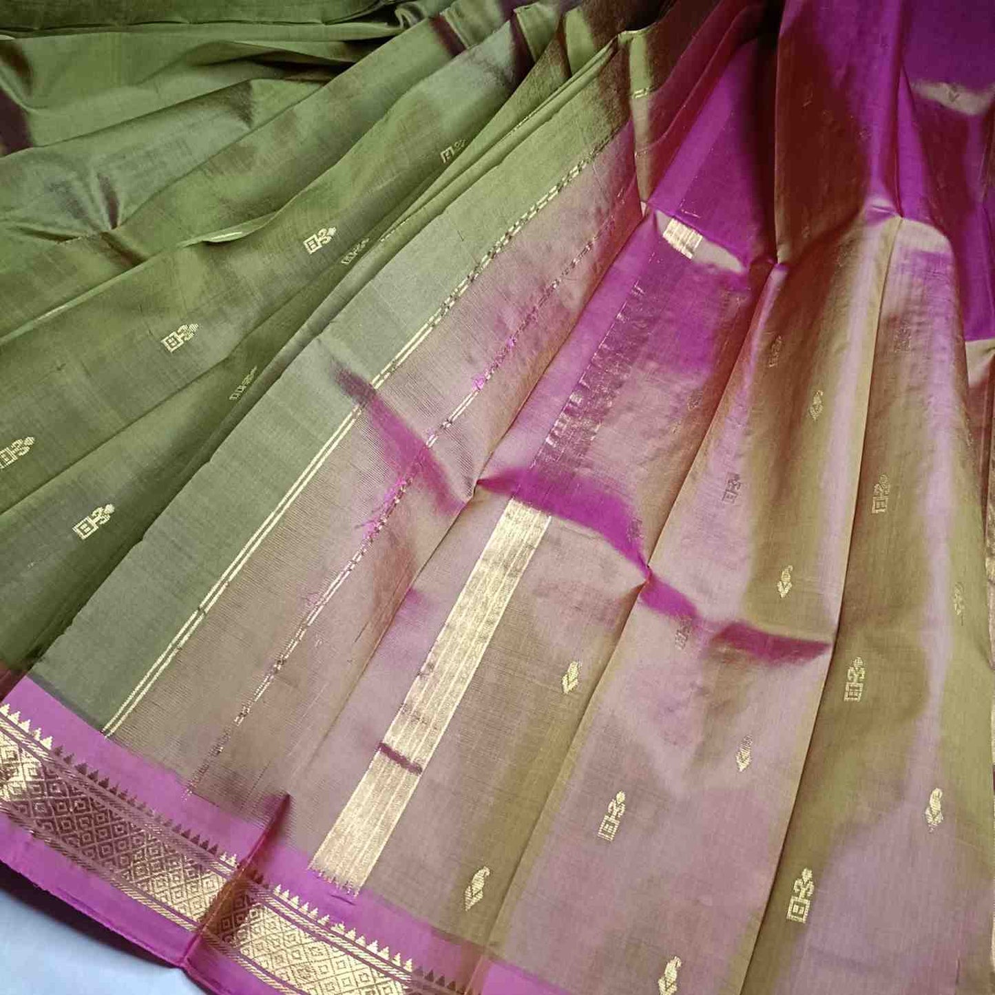 Dual Shade Olive Green and pink pallu with thin zari lines and small buttas  on Thirubhuvanam silk saree