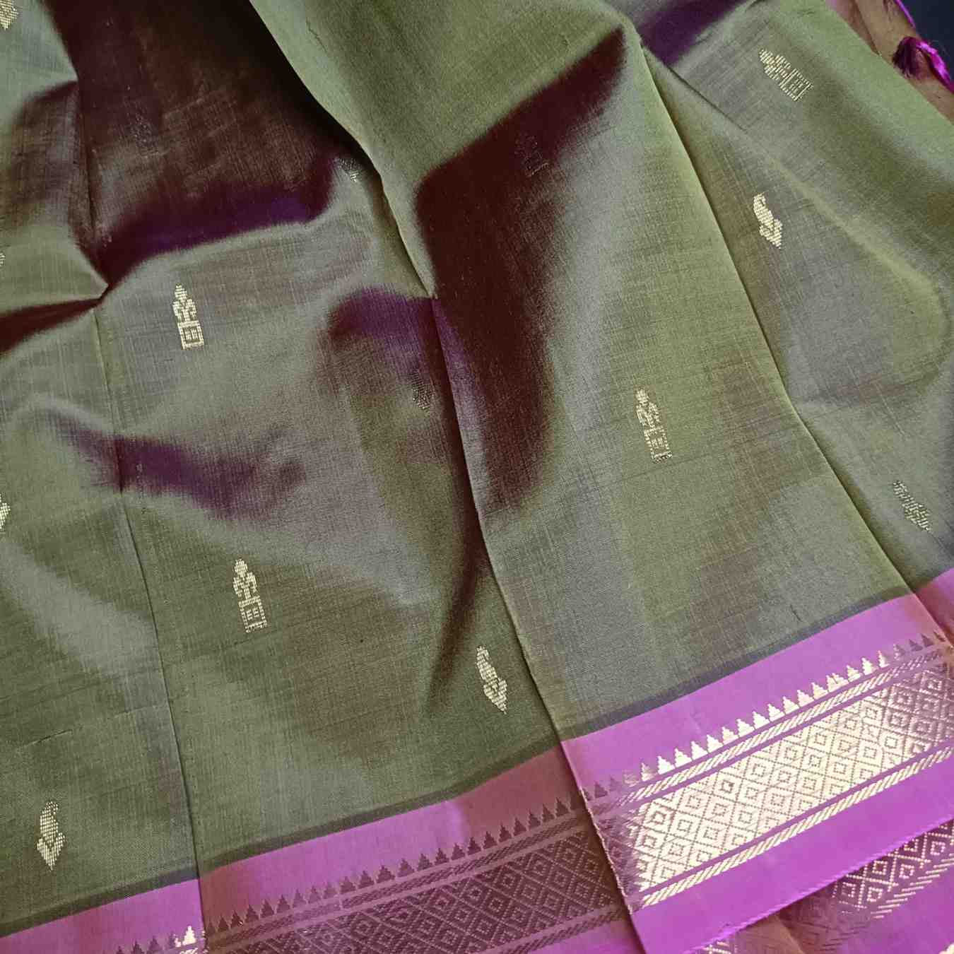 Close-up of pink Temple border on olive green Thirubhuvanam silk saree