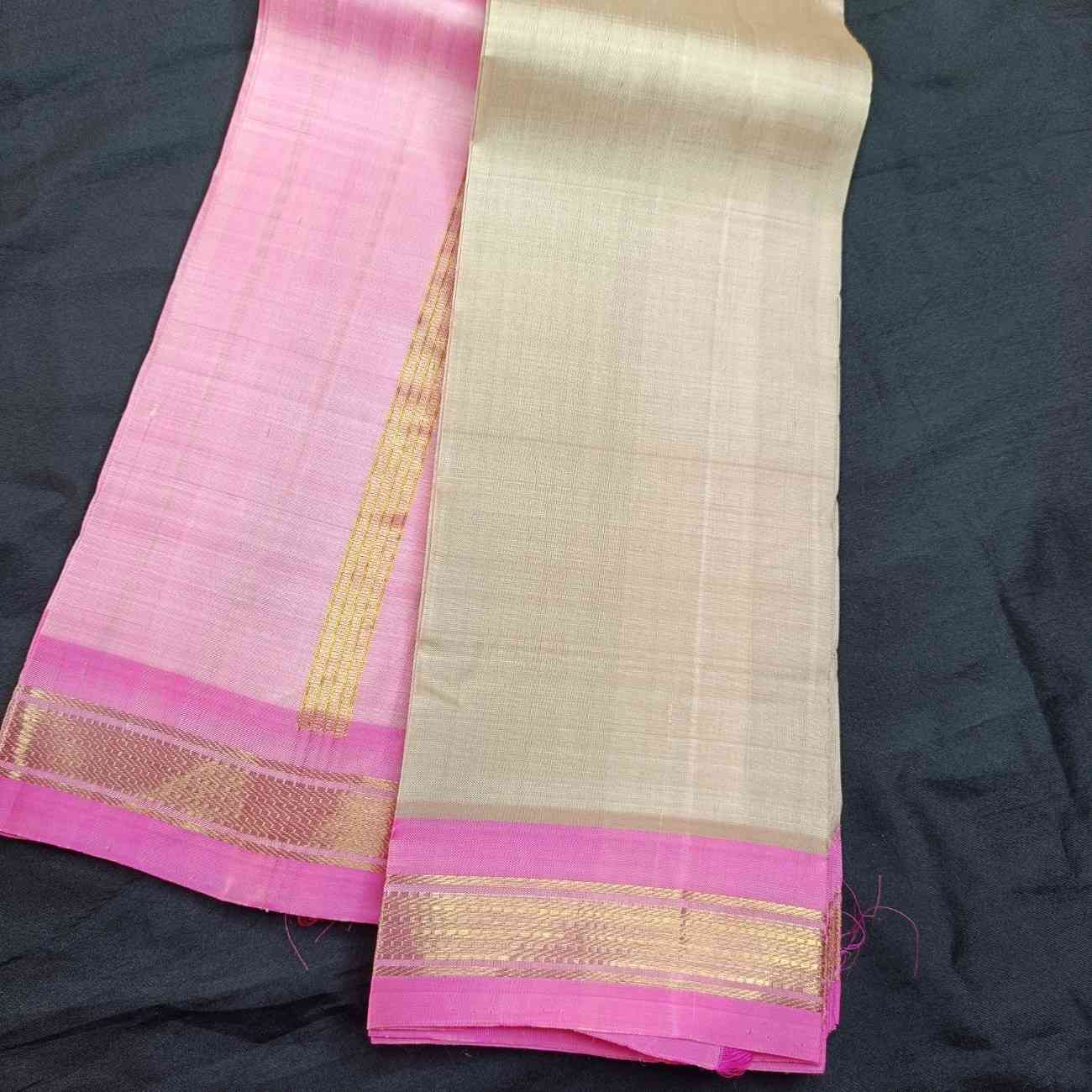 Close-up of lotus pink Bhavanji border on ivory off-white Thirubhuvanam silk saree