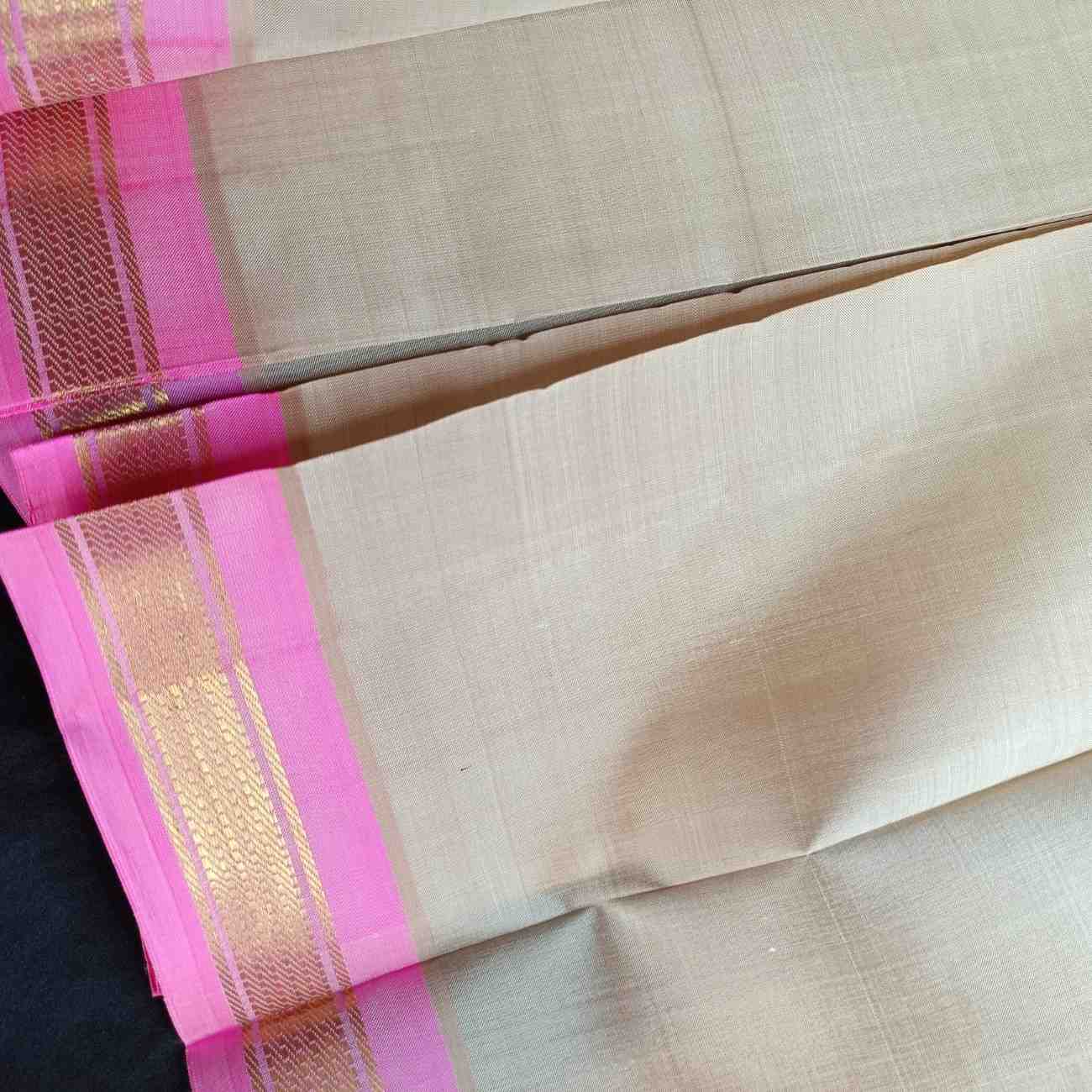 Close-up of lotus pink Bhavanji border on ivory off-white Thirubhuvanam silk saree