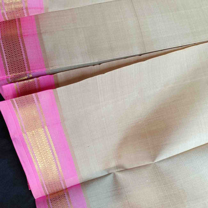 Close-up of lotus pink Bhavanji border on ivory off-white Thirubhuvanam silk saree