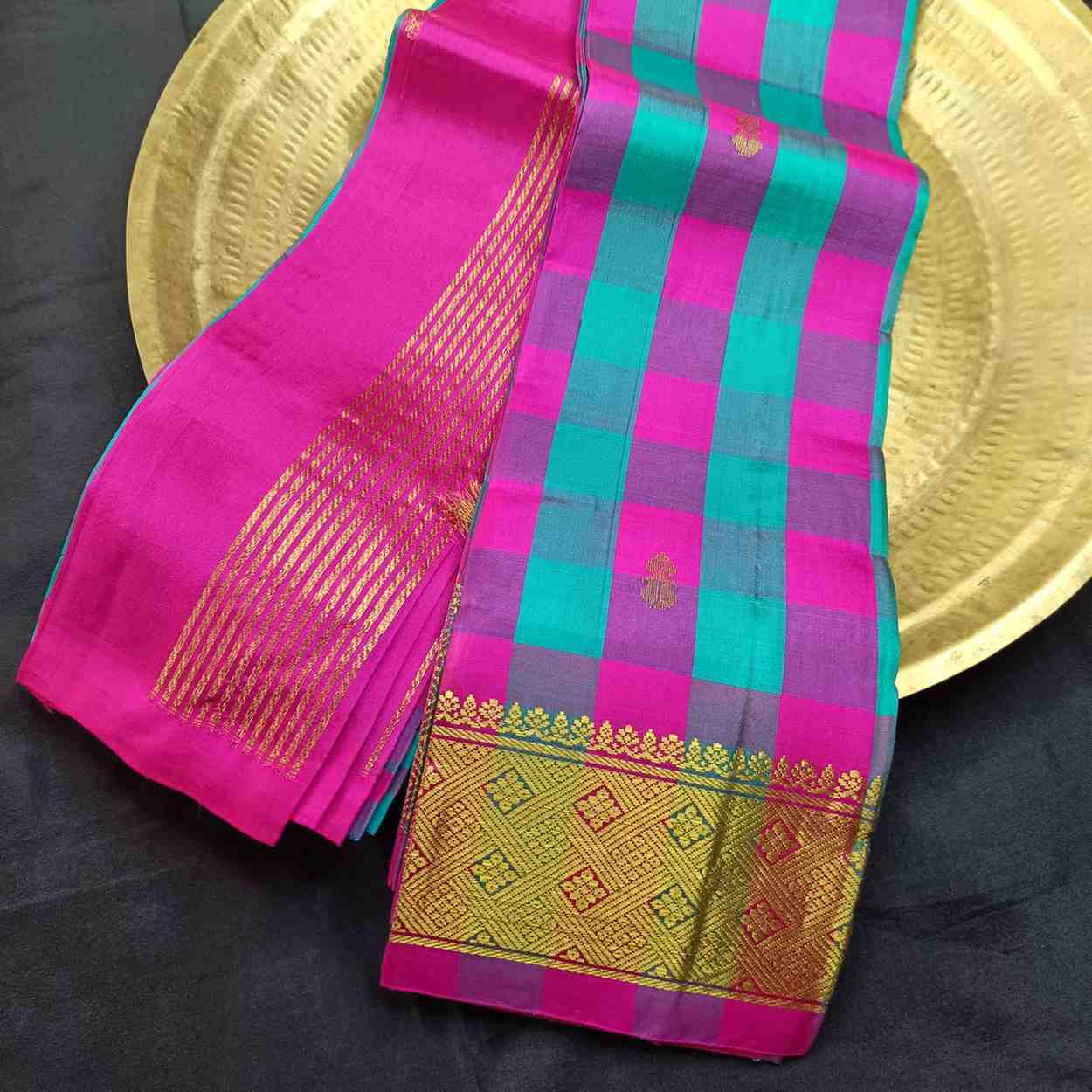 Colorful saree with pink and green patterns on a black background