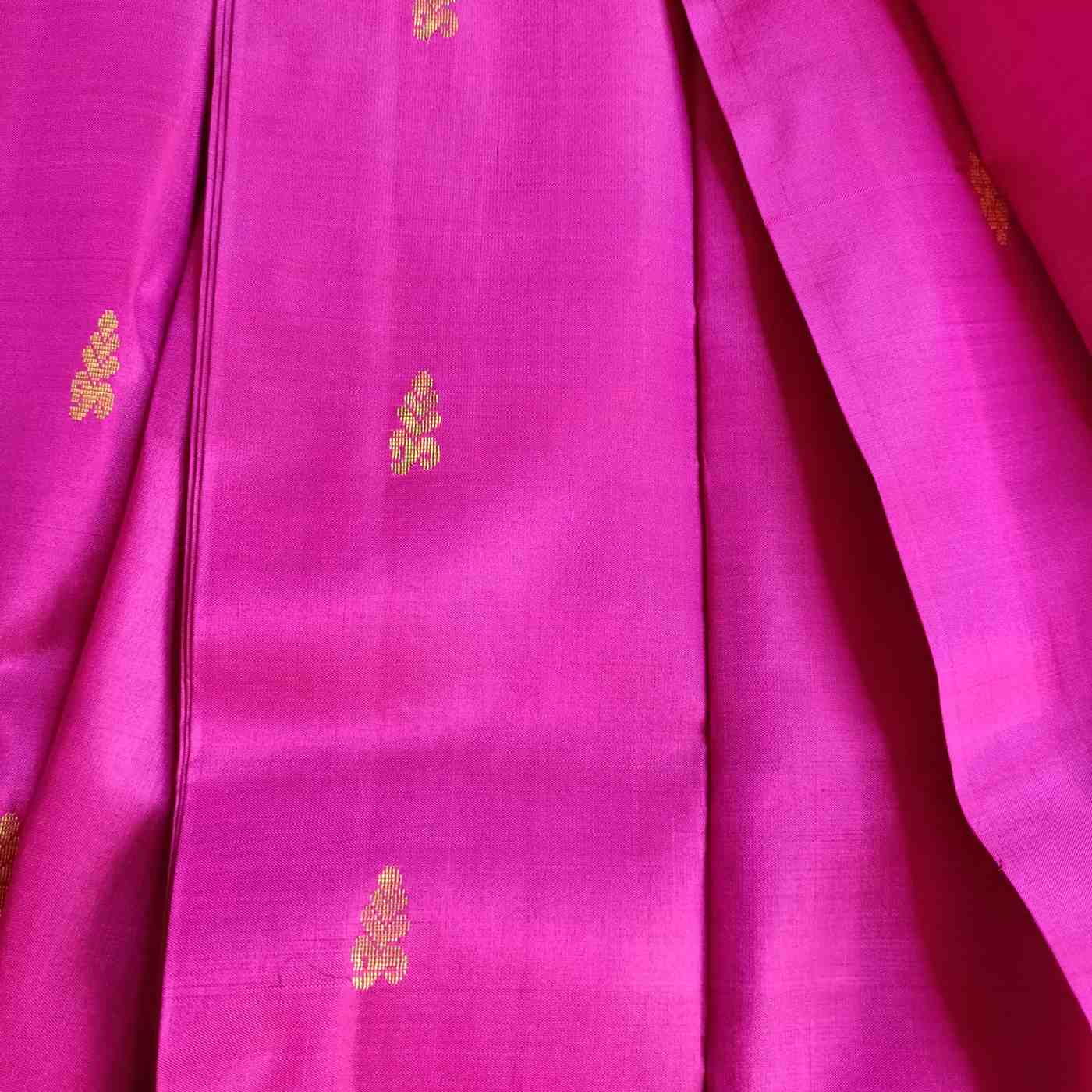 Close-up of a pink fabric with gold embroidery