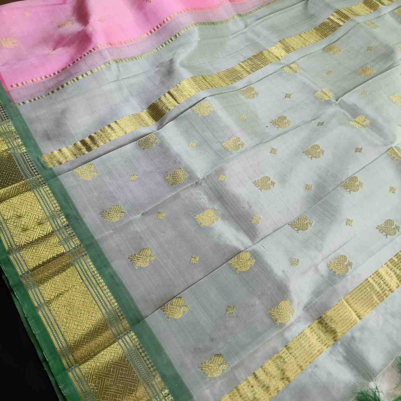 Pink Thirubhuvanam silk saree pallu with golden zari work and Annapakshi design
