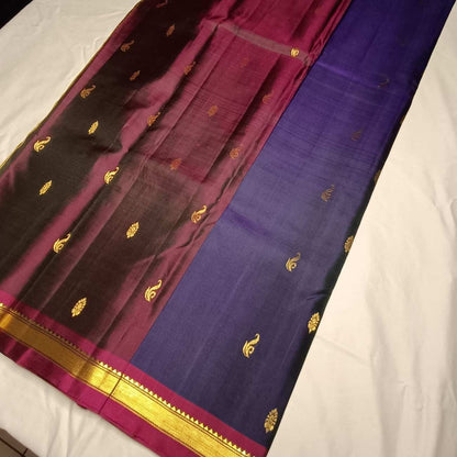 Image 1: Pure handloom navy blue Kanjivaram silk saree with Vanki Butta motifs full view

Image 2: Close-up of contrast Arakku-Paaku wine temple border on navy blue Kanjivaram saree

Image 3: Traditional Saada Vanki Butta motifs with Kasam Butta fillers on navy silk

Image 4: Navy blue Kanjivaram silk saree pallu in Arakku-Paaku wine with zari lines

Image 5: Pure mulberry silk Kanjivaram fabric showing deep navy blue tonal weave

Image 6: Contrast wine blouse piece with navy blue Kanjivaram silk saree

Ima