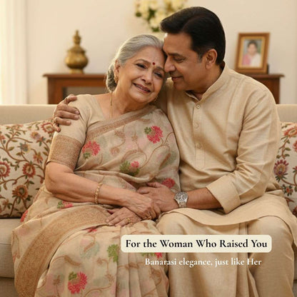Man and woman sitting together on a couch, with text about Banarasi elegance.